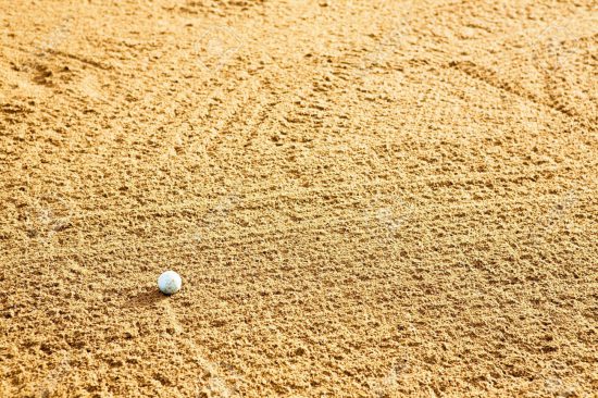 3418758-A-golf-ball-in-a-sand-trap-Stock-Photo